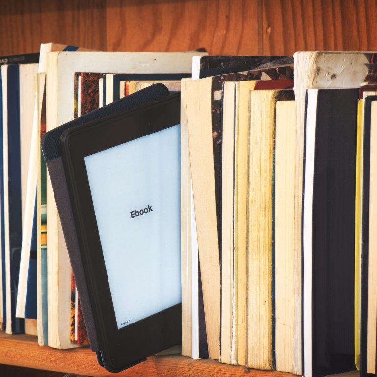 a picture of an ipad on a bookshelf surrounded by books showing all you need to know about selling an ebook on amazon